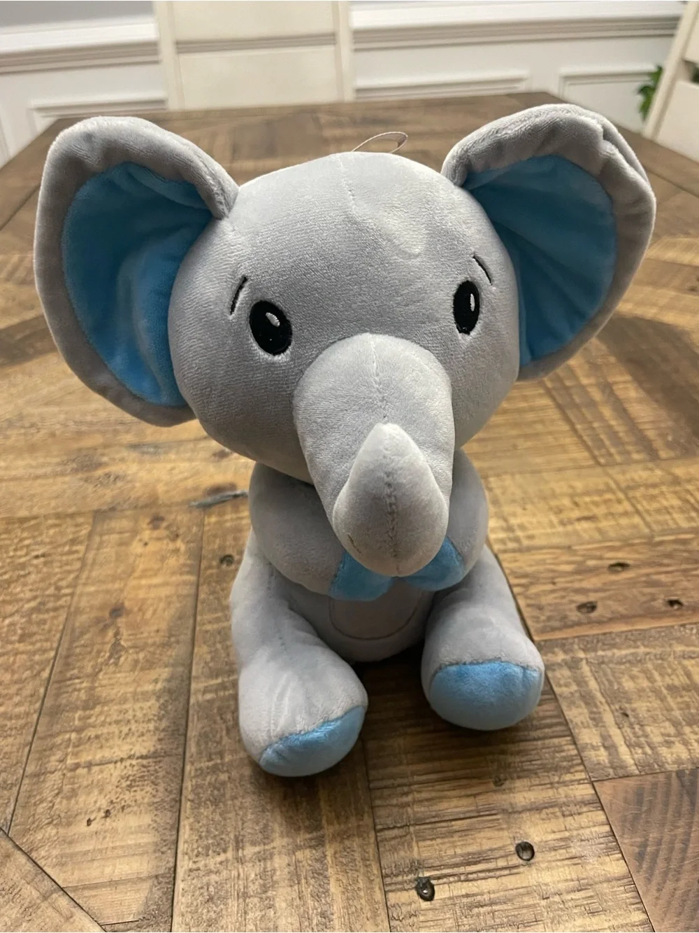 Amscan plush elephant balloon weight featuring blue ears and blue feet